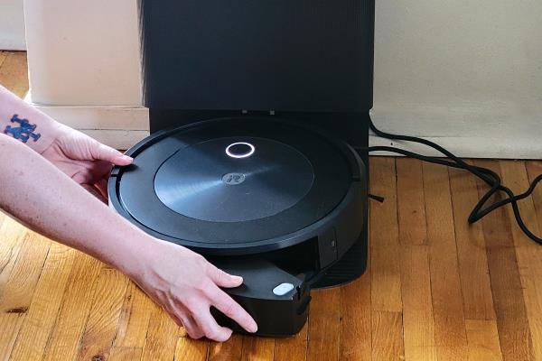 Roomba j7+ Self-Emptying Vacuum charging on hardwood floor