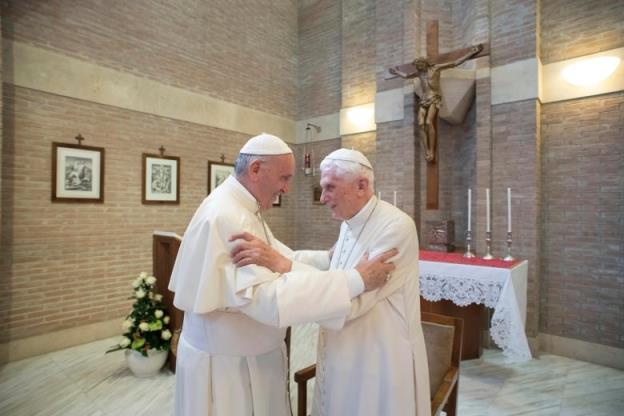Pope Francis, left, greets the former pope Benedict.