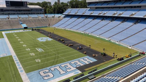 Crews from Carolina Green and the University of North Carolina Turf Management install nearly 100,000 square feet of fresh sod atop the artificial turf in Kenan Stadium in preparation for the FC Series game between Chelsea and Wrexham on Wednesday, July 12, 2023 in Chapel Hill, N.C. The Bermuda 419 sod was grown in Indian Trail, N.C., is 1.5 inches thick, and was installed upon a layer of geo-textile ba<em></em>se over the artificial turf, which will be removed following the soccer match on July 19, 2023.